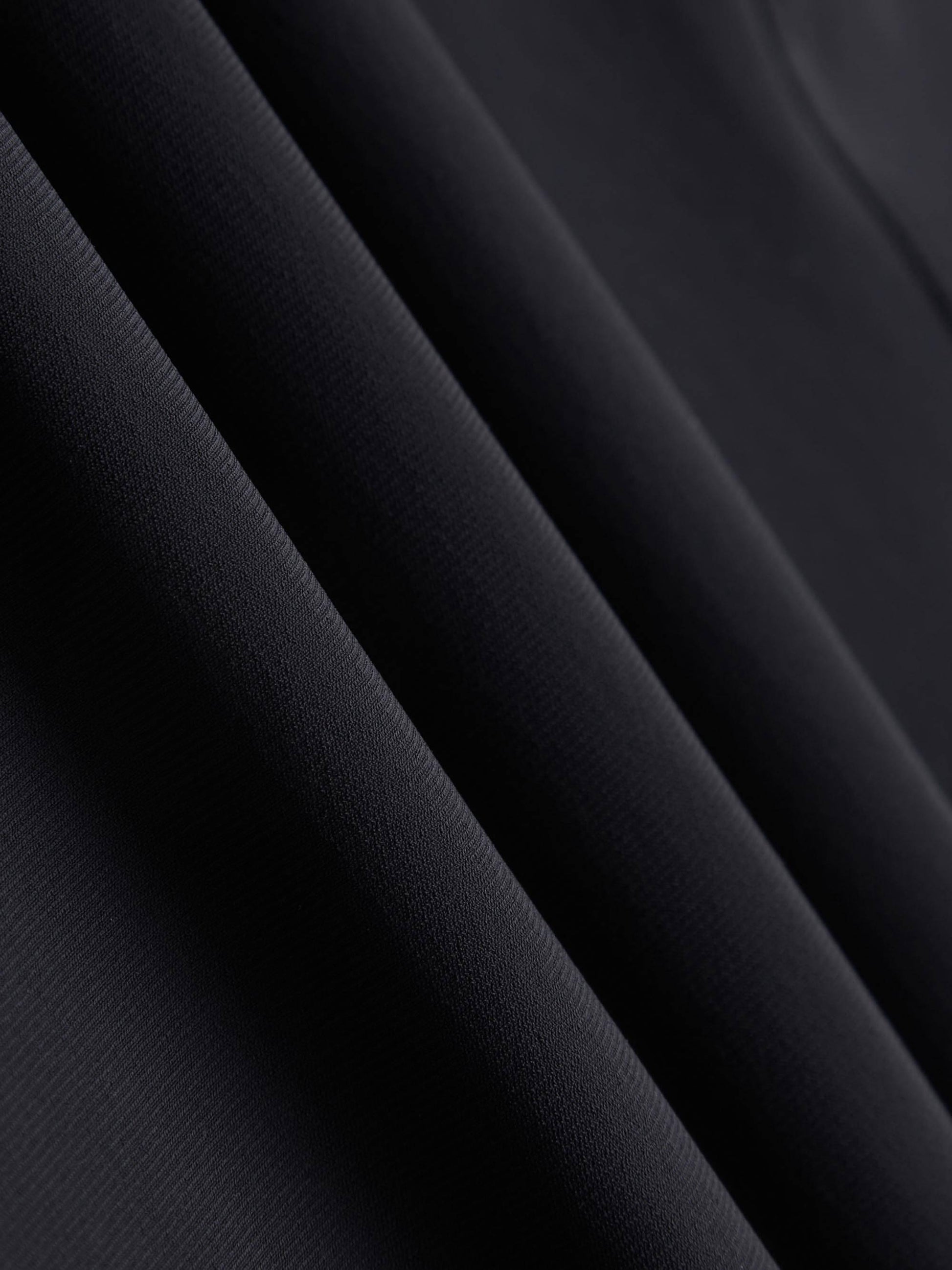 A close-up image of a black fabric, showing its texture and smooth surface.