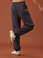 back of woman in dark purple pants