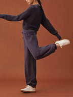 woman in dark purple sweater and pants