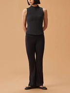woman in black crew neck sleeveless top and black flare pants