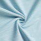 Close-up of light blue ribbed fabric, twisted into a spiral pattern.