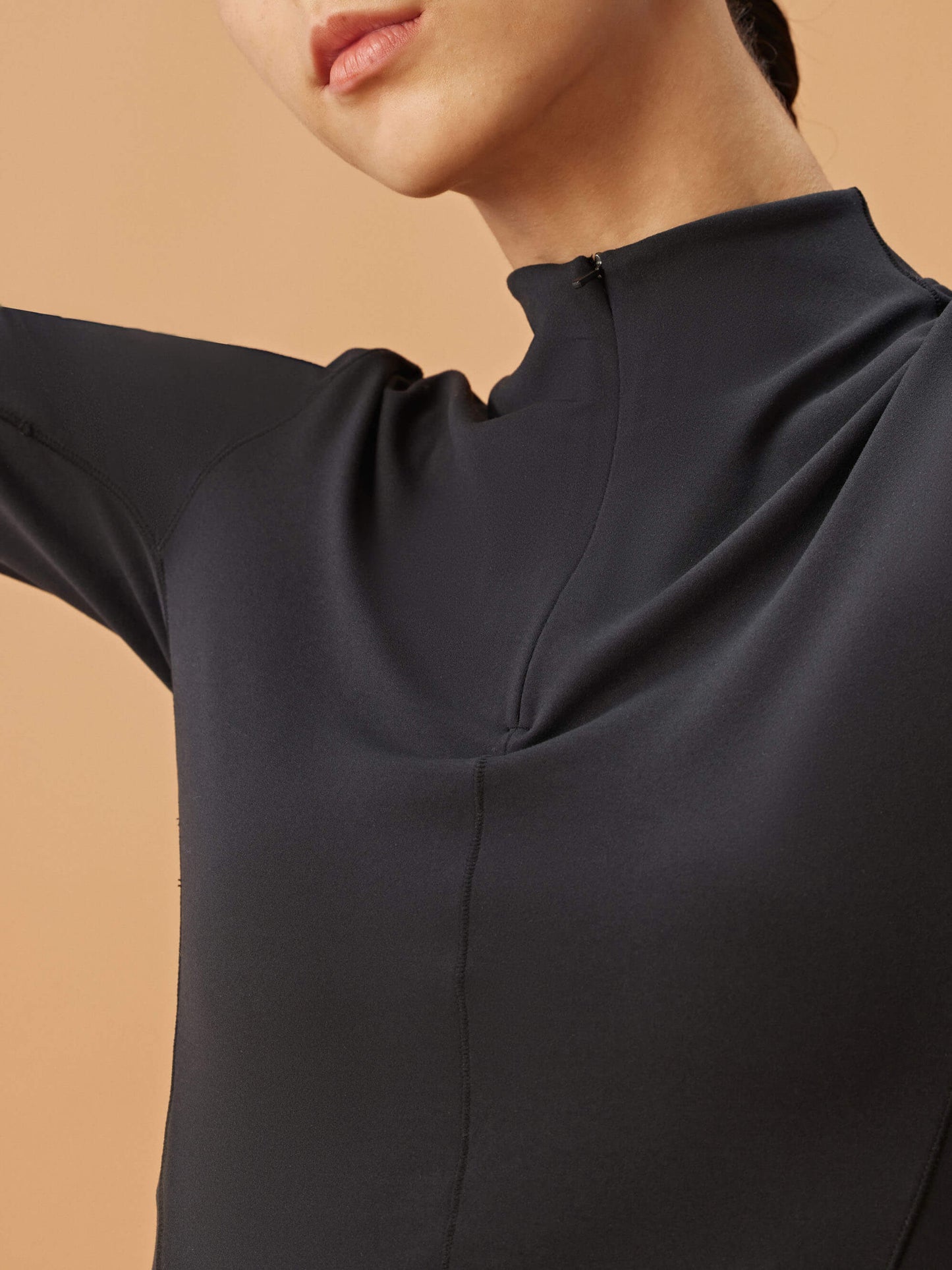 Closeup of black half zip long sleeve top