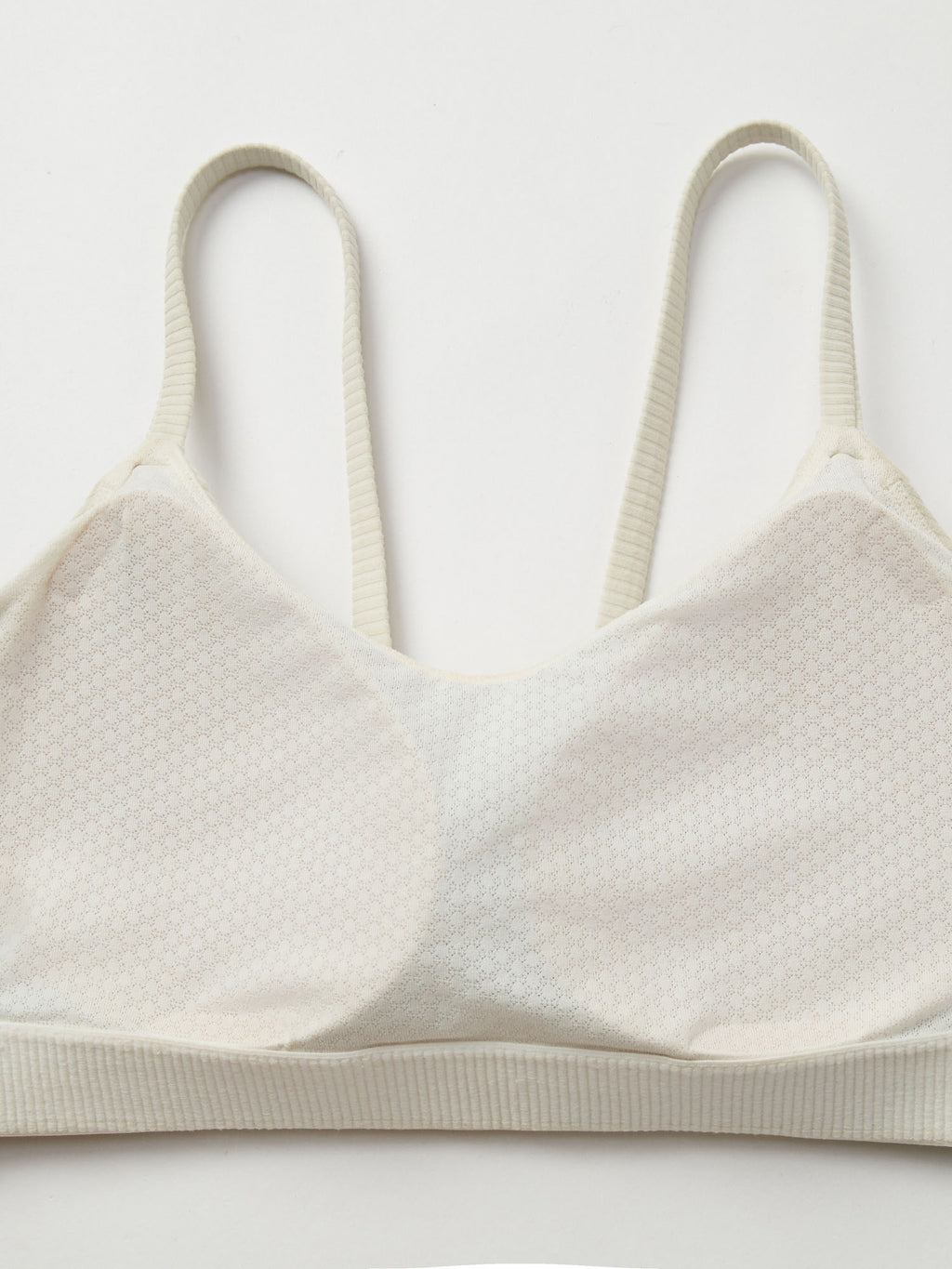 Closeup pf fixed cup on a white sports bra.