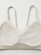 Closeup pf fixed cup on a white sports bra.