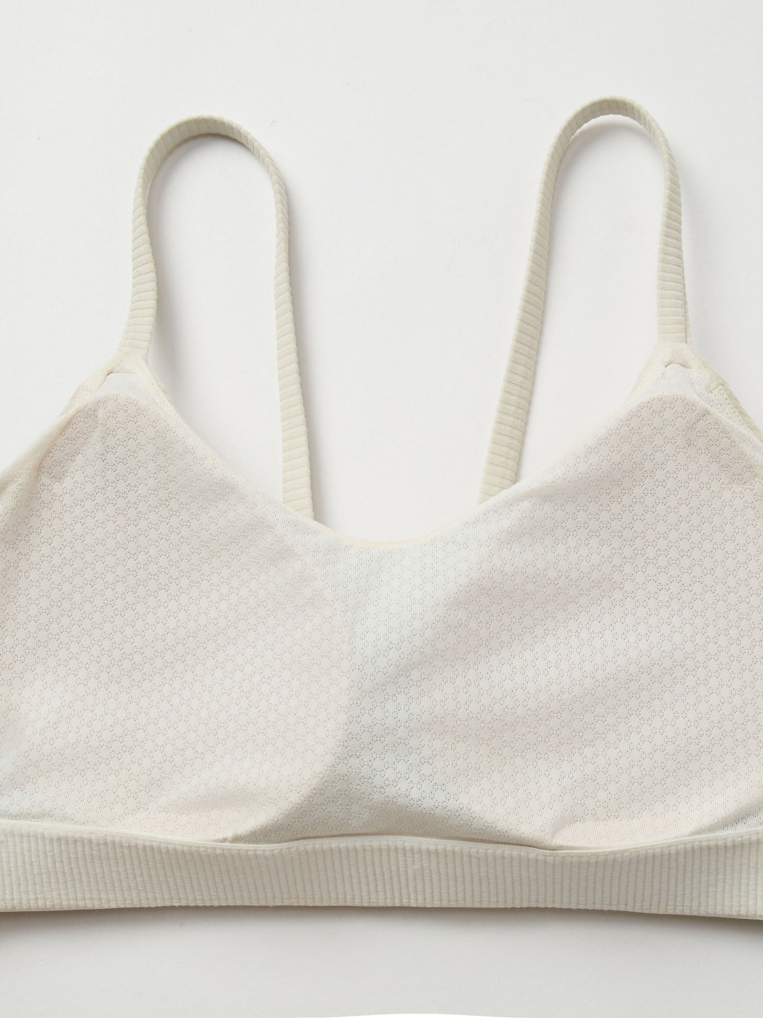 Closeup pf fixed cup on a white sports bra.