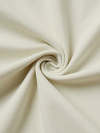 Close-up of beige fabric with a swirl pattern