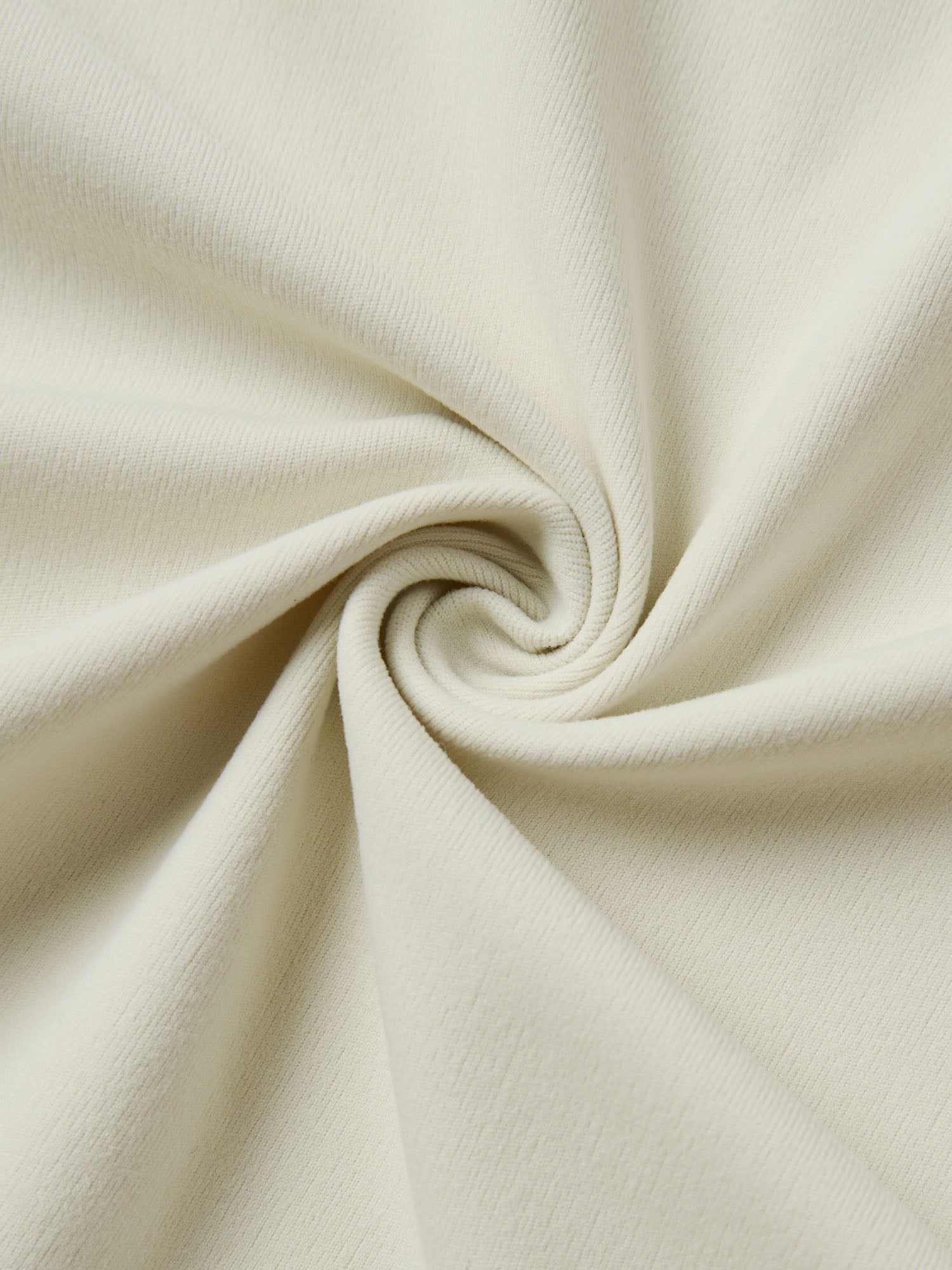 Close-up of beige fabric with a swirl pattern