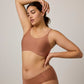 Woman wearing rust-colored tank bra with matching brief
