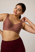 woman in brick color bra and maroon bottoms