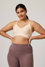 woman wearing an off white bra and light purple bottoms