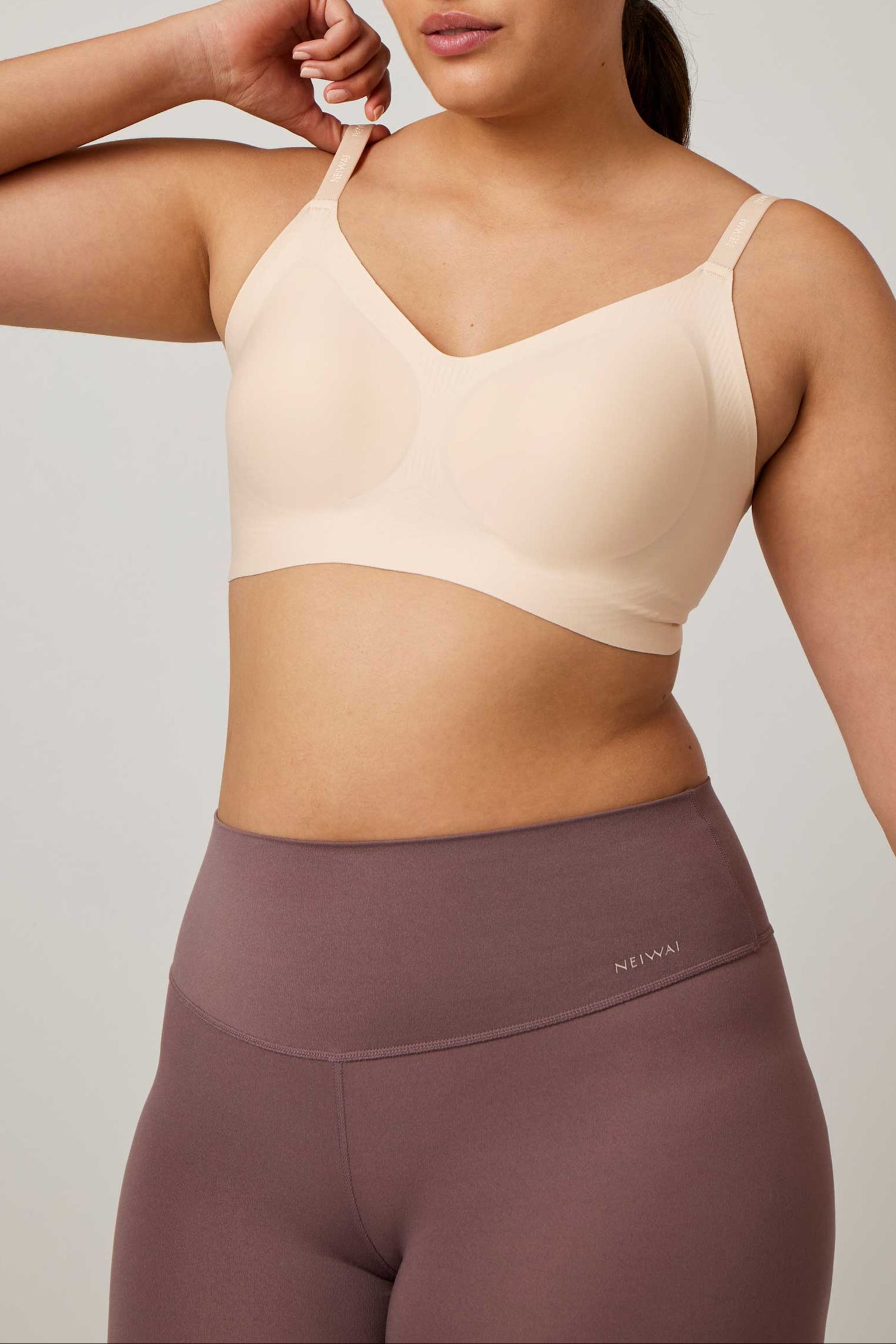 woman wearing an off white bra and light purple bottoms