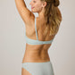 back of woman in blue bra and brief
