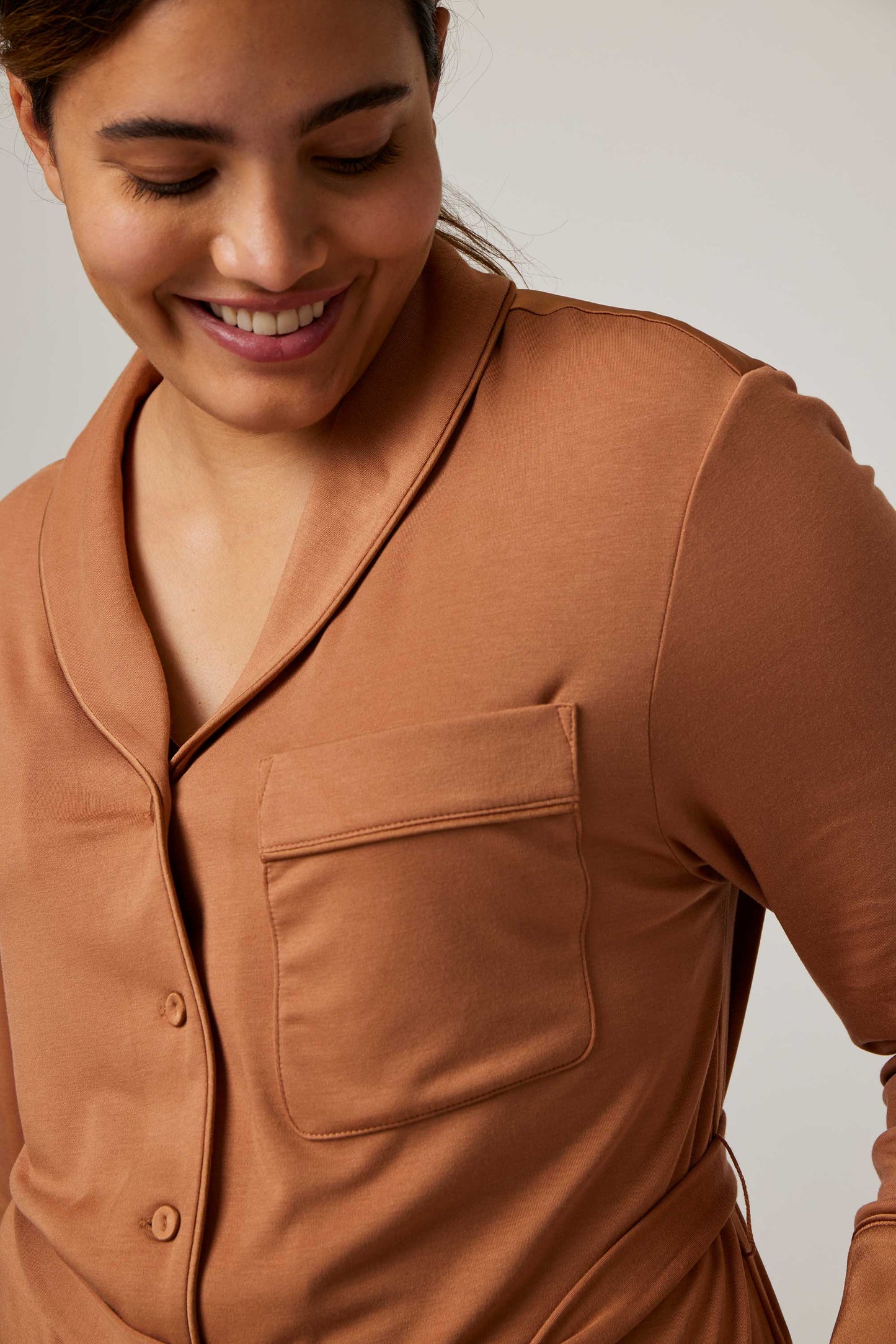 close up of woman in caramel pajama top