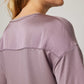 back of woman in purple pajama t-shirt