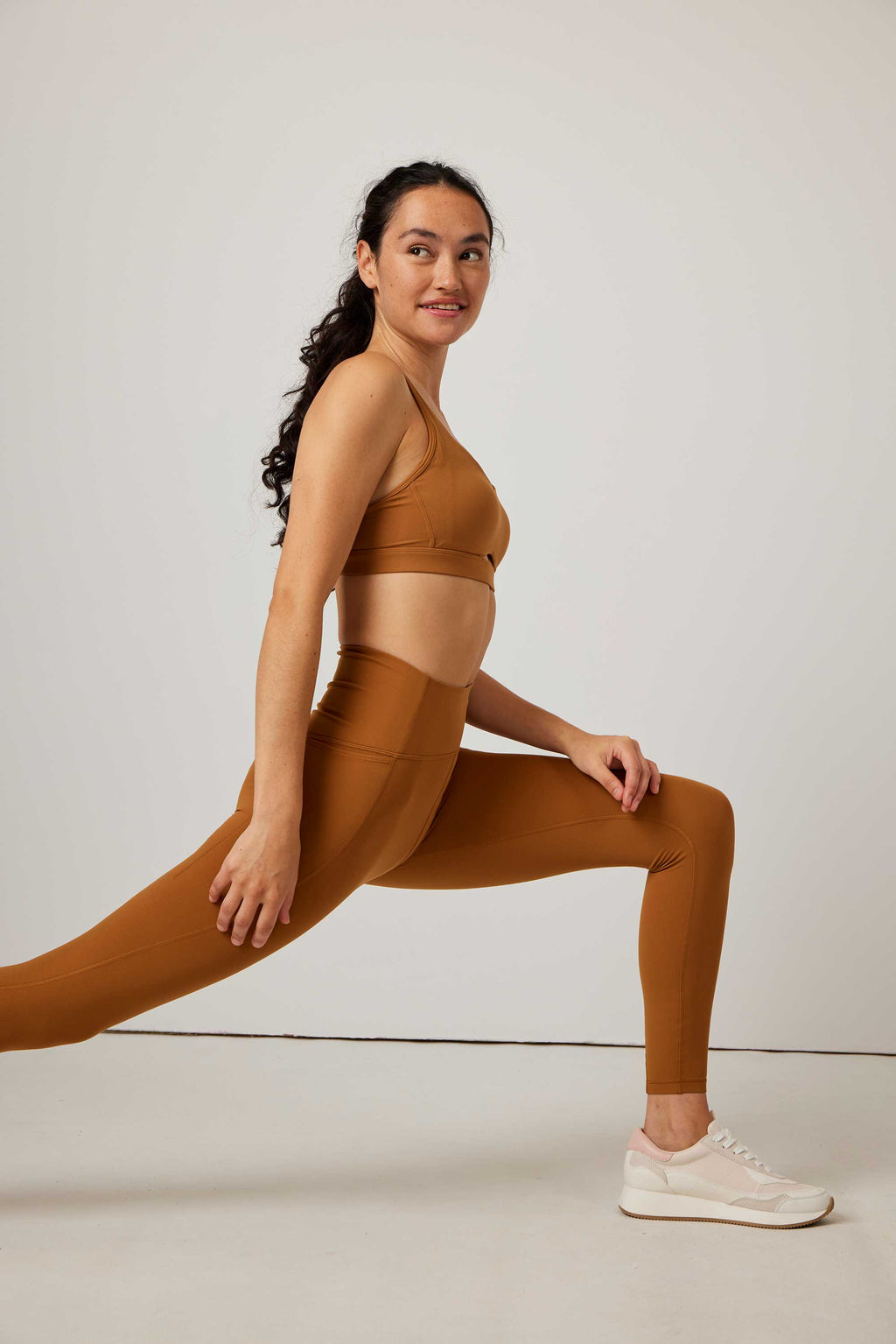 woman in mustard sports bra and leggings