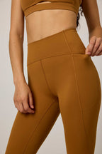 woman in mustard sports leggings