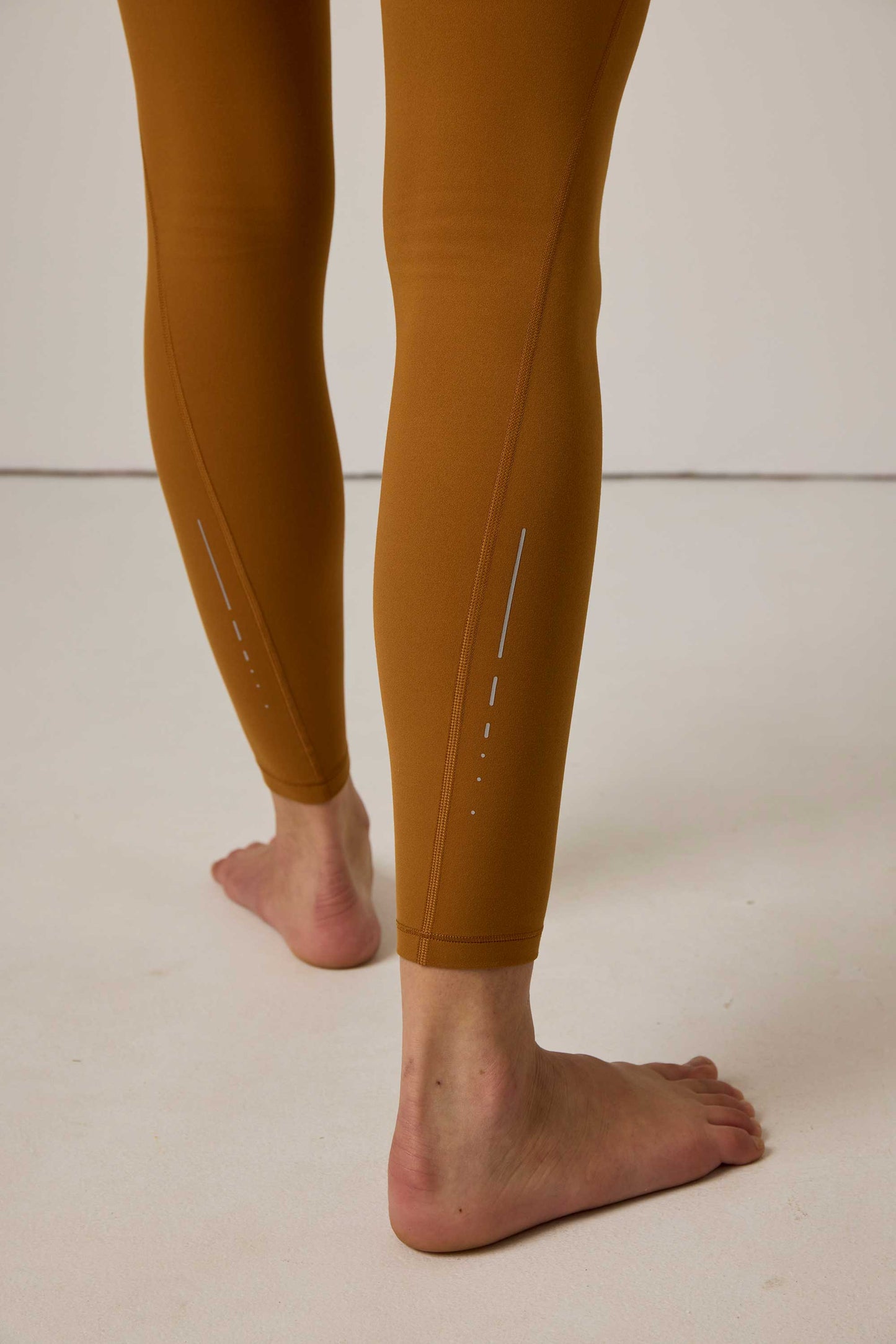 close up of woman in mustard leggings