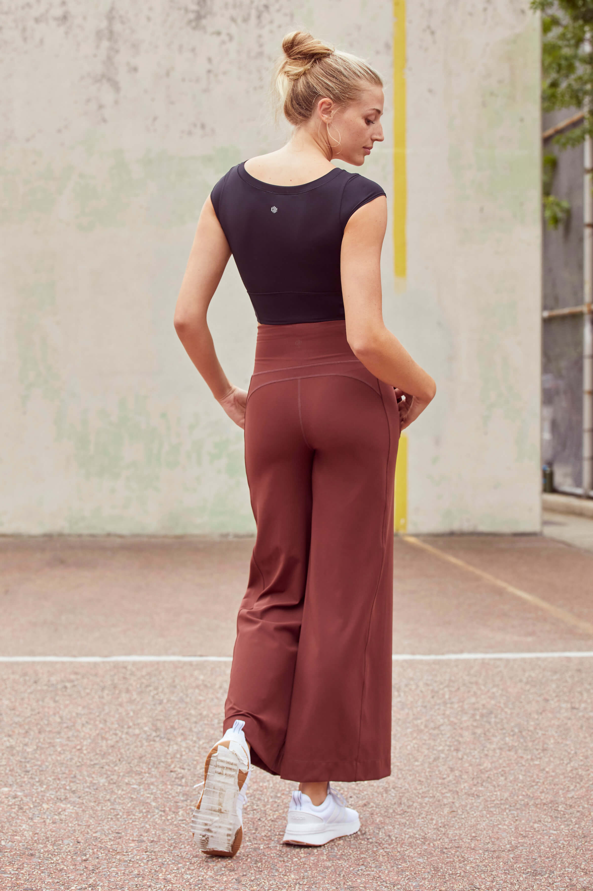 A woman wearing red pants