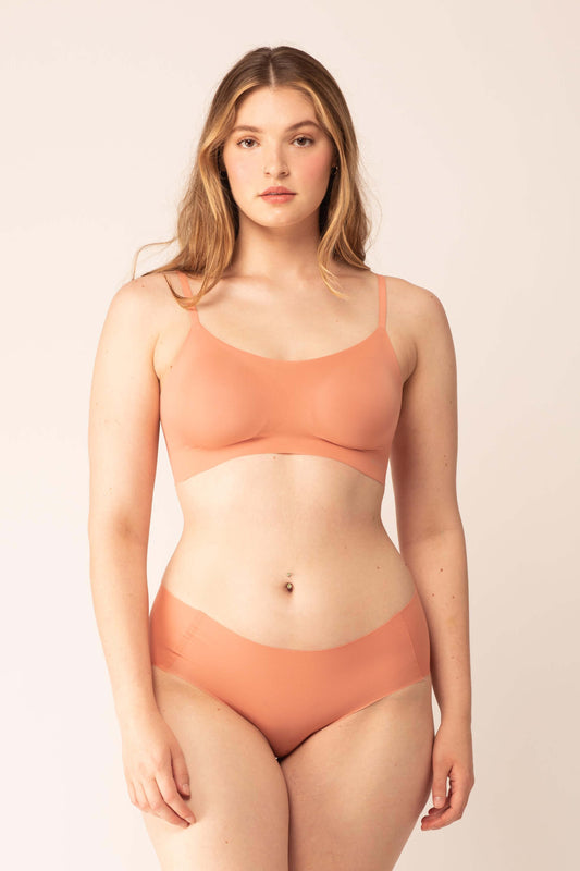 woman in maple syrup color bra and brief