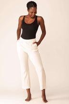 woman in black bodysuit and white pants