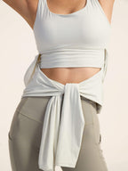 Closeup of white long sleeve top on model.