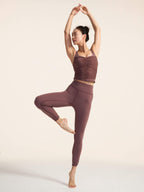 Model wearing brown tank top and knot leggings posing 