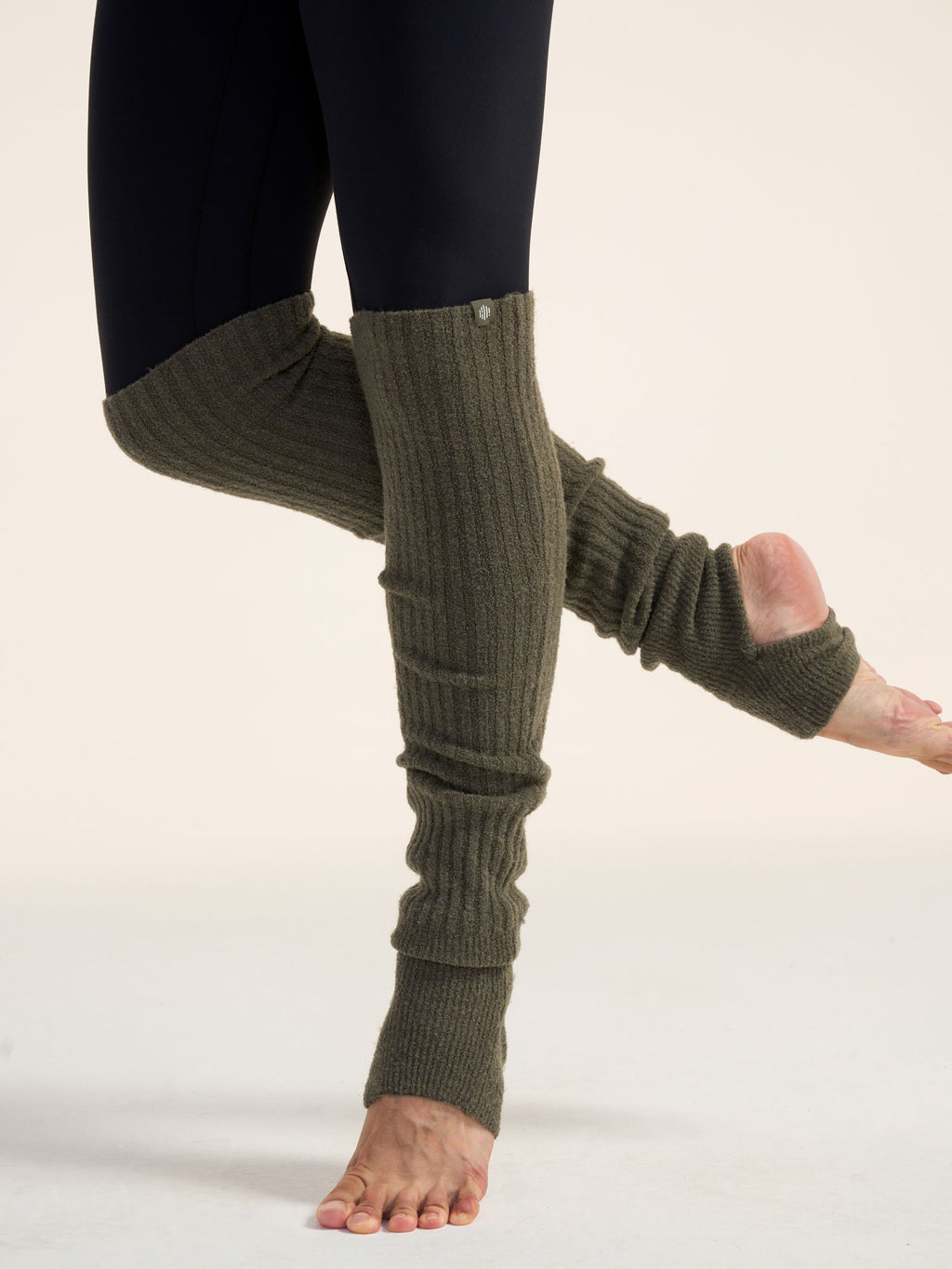 Model wearing olive green leg warmers.