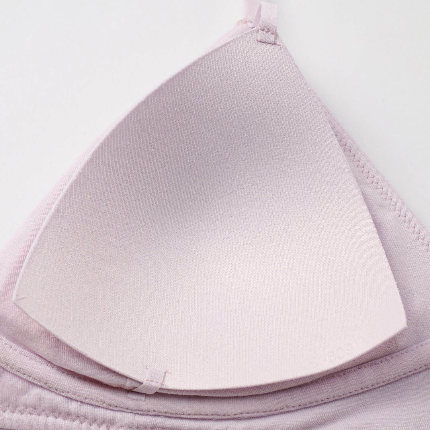 Close-up of a light purple bra on a white background