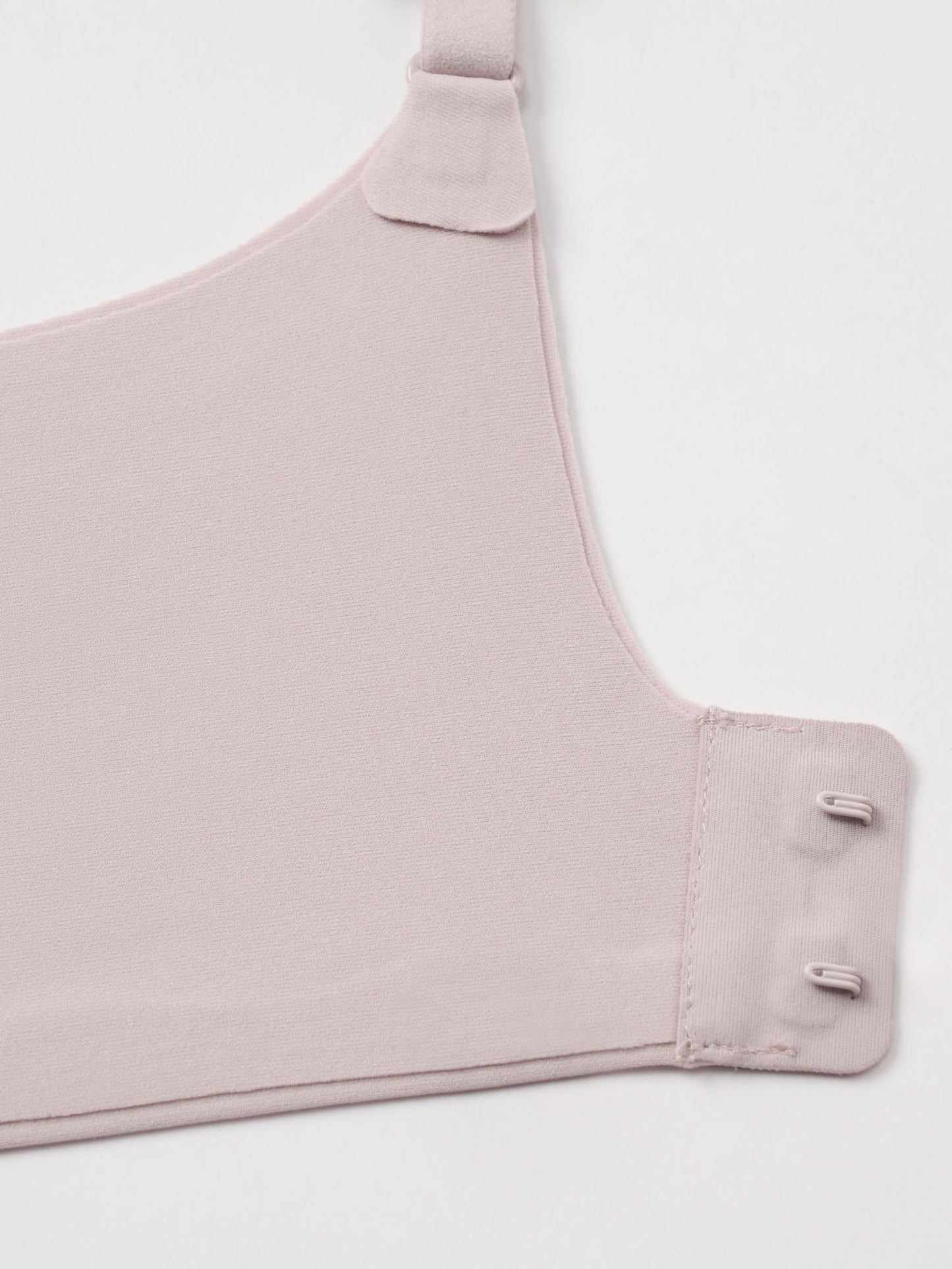 Closeup of light nude colored bra clasps.