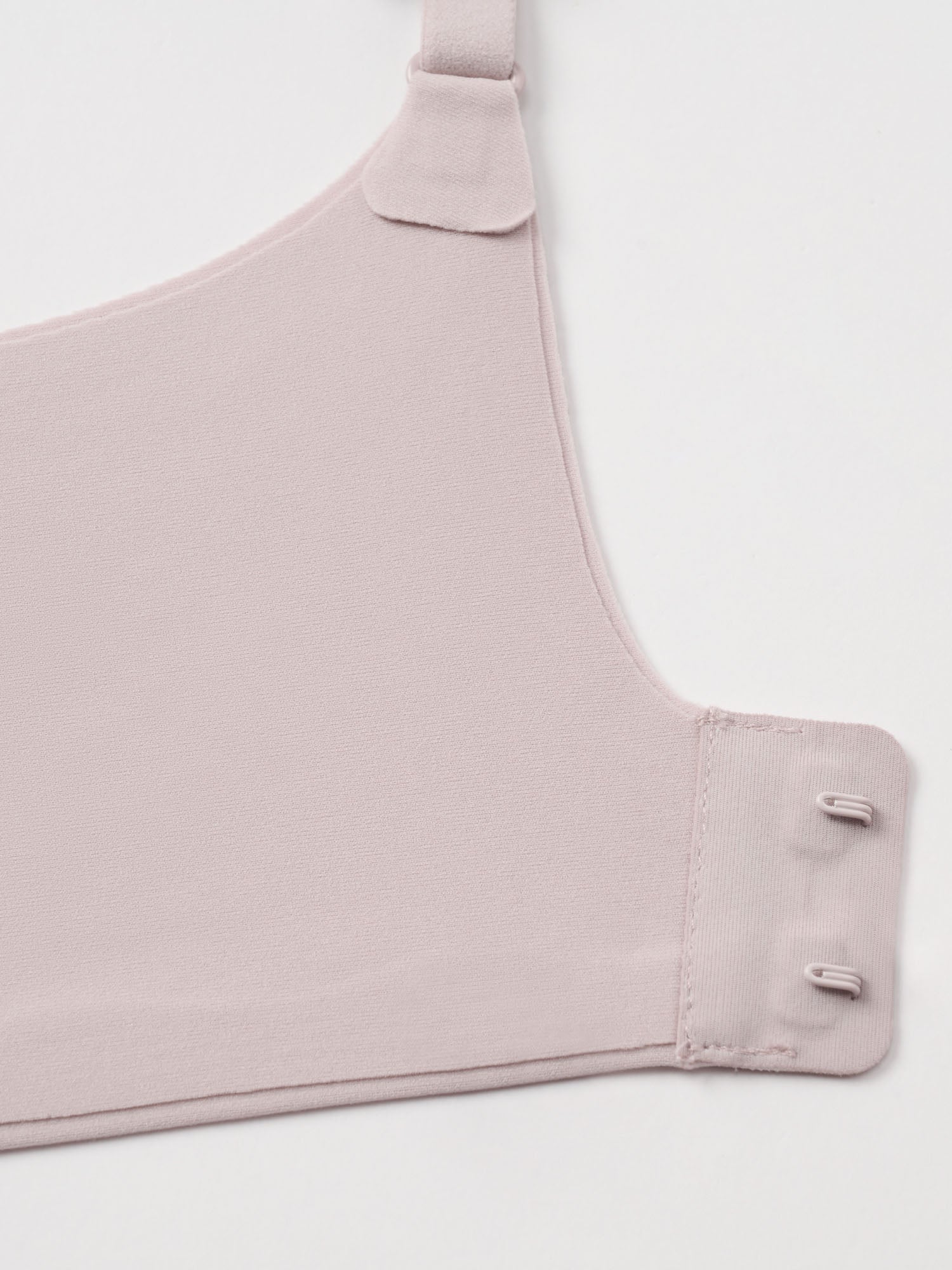 Closeup of light nude colored bra clasps.
