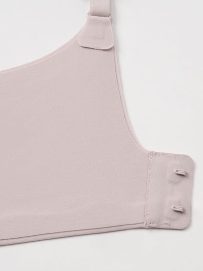 Closeup of light nude colored bra clasps.