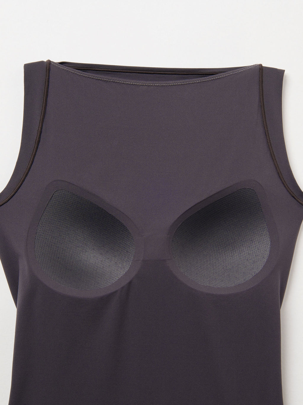 Black tank top with silicone bra inserts on a white background