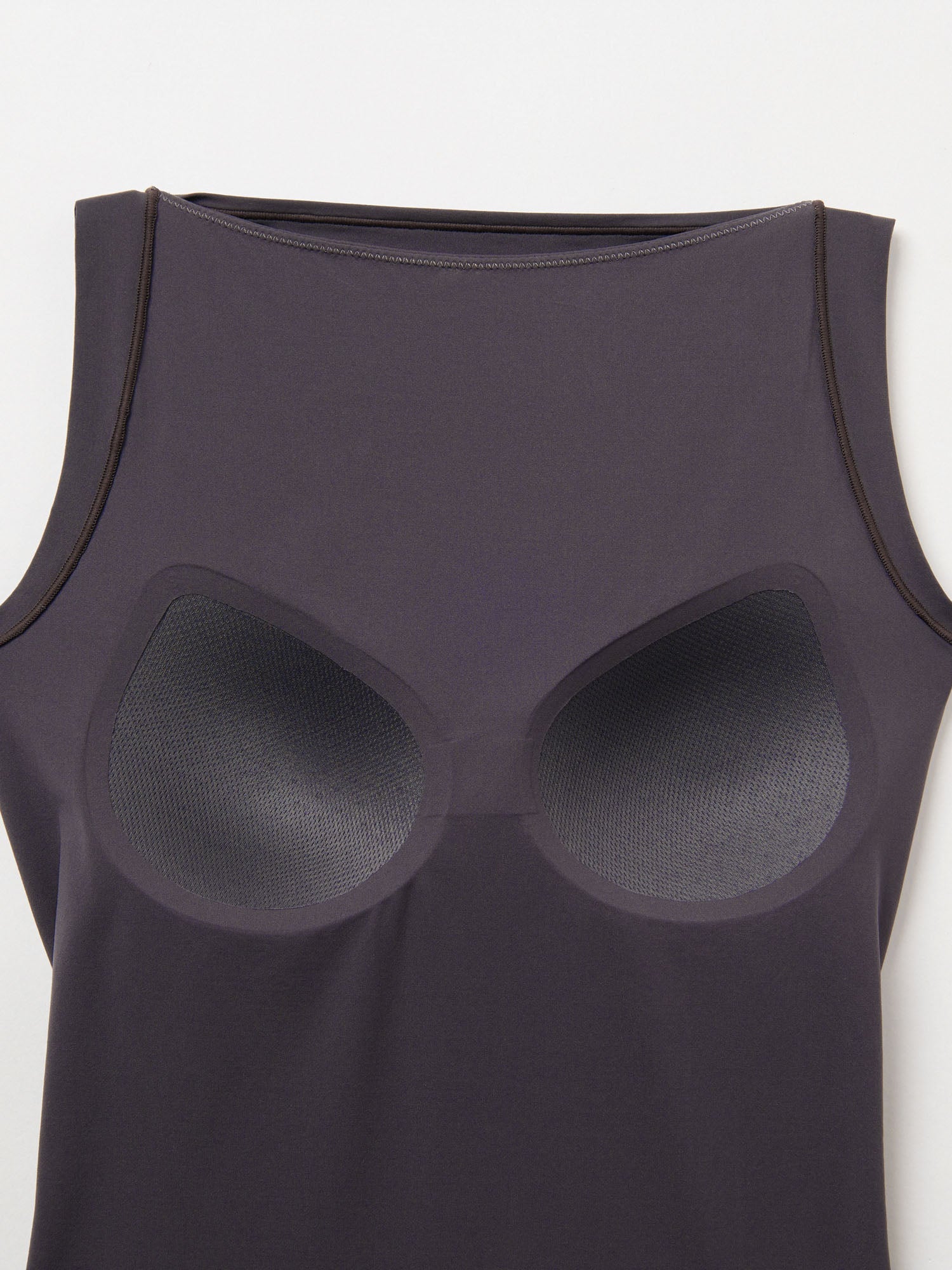 Black tank top with silicone bra inserts on a white background