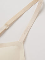 Close up of thin bra strap with NEIWAI logo. Sugar Swizzle color.