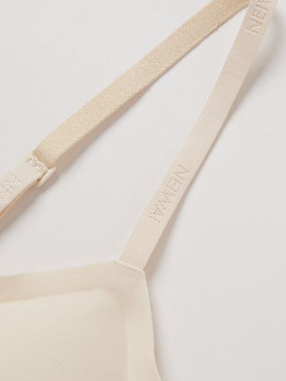 Close up of thin bra strap with NEIWAI logo