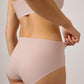 back of woman wearing light pink bra and brief