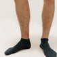 a person wearing a navy ankle socks