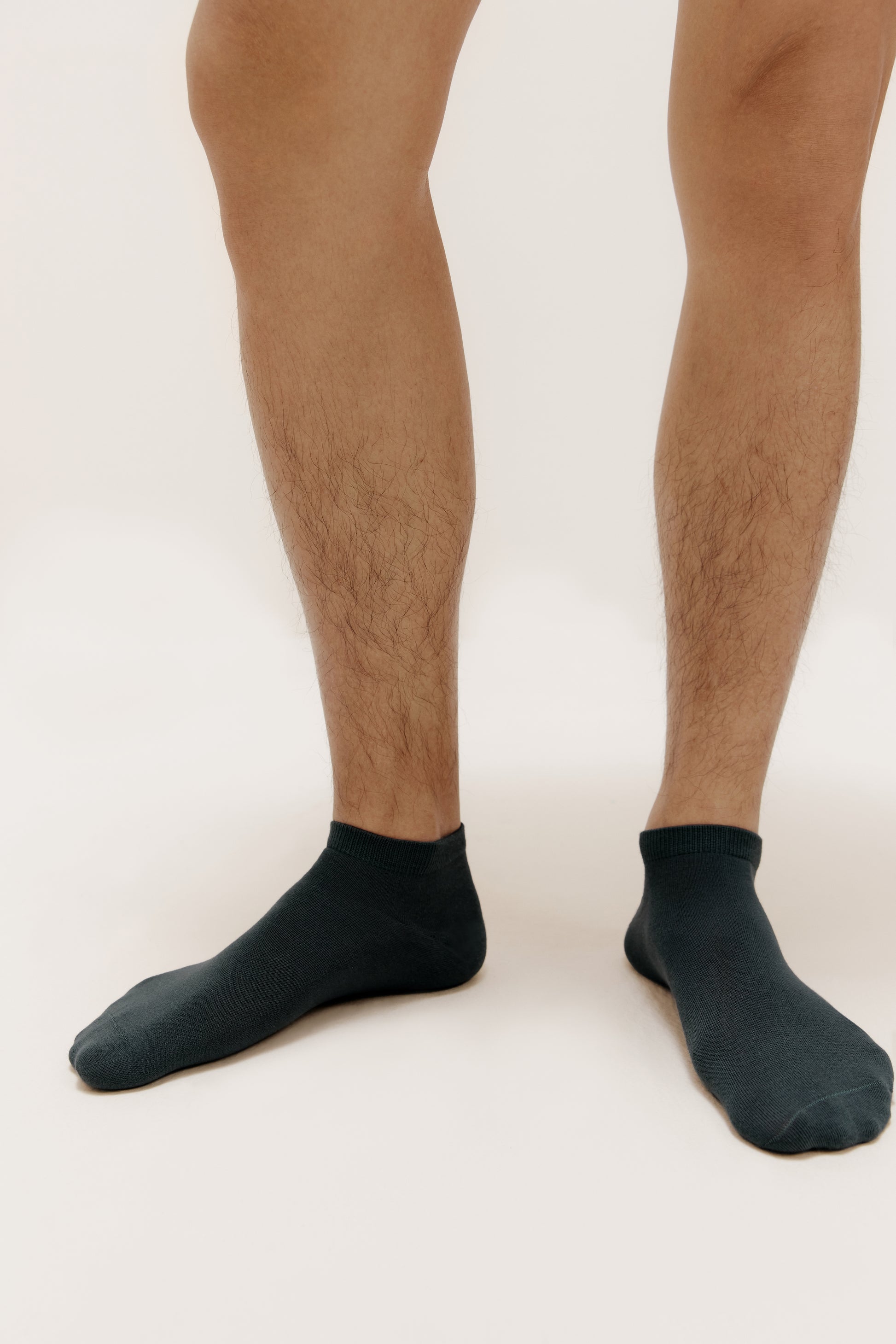 a person wearing a navy ankle socks