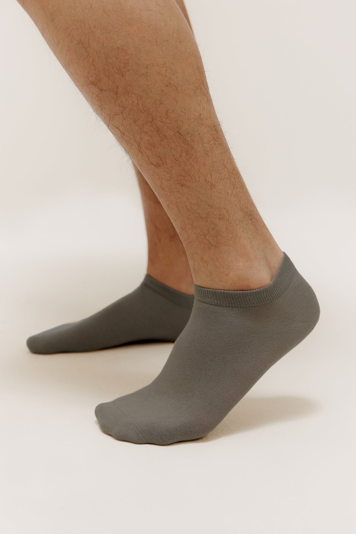 side view of a person wearing dark grey socks