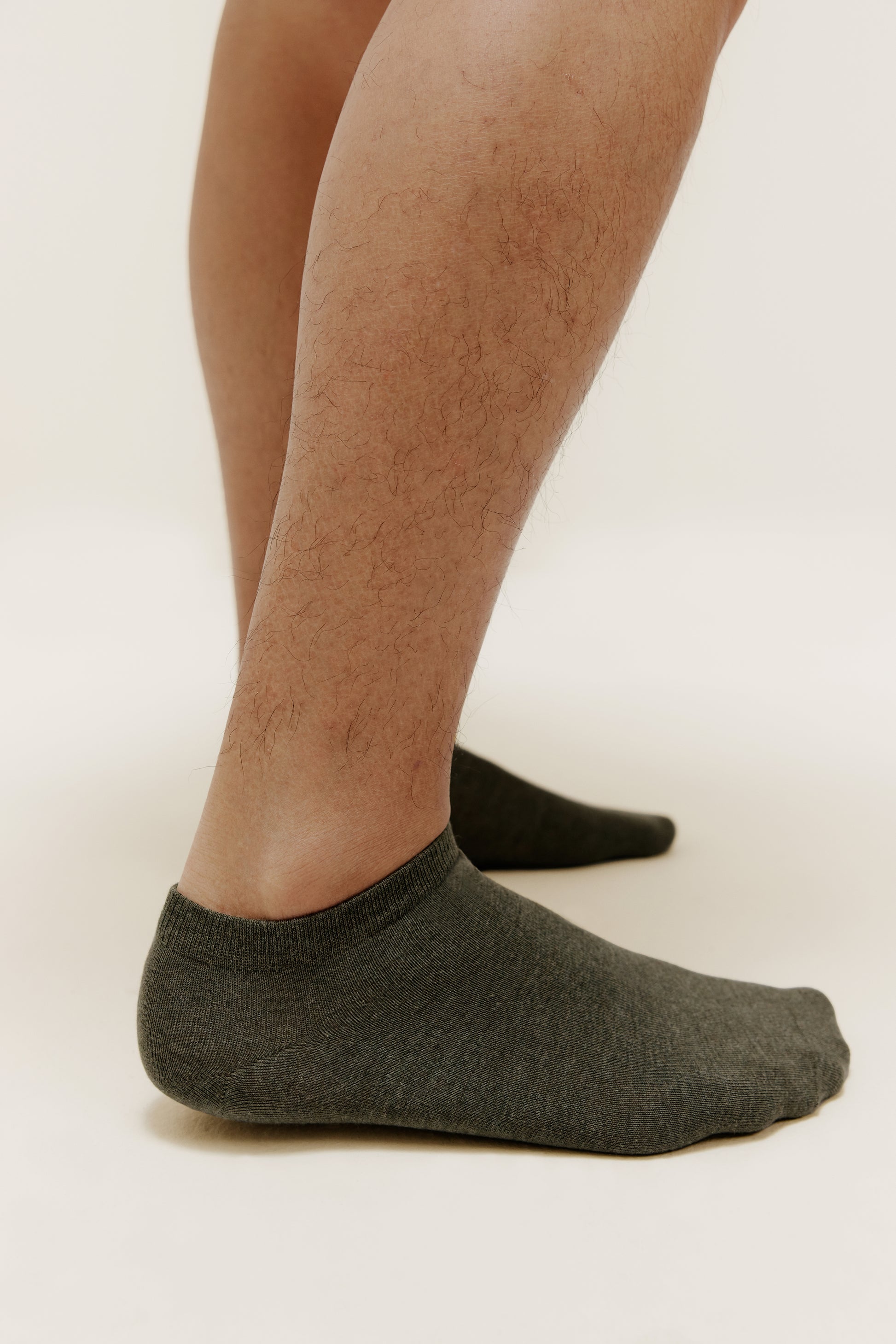 side view of a person wearing dark green ankle socks