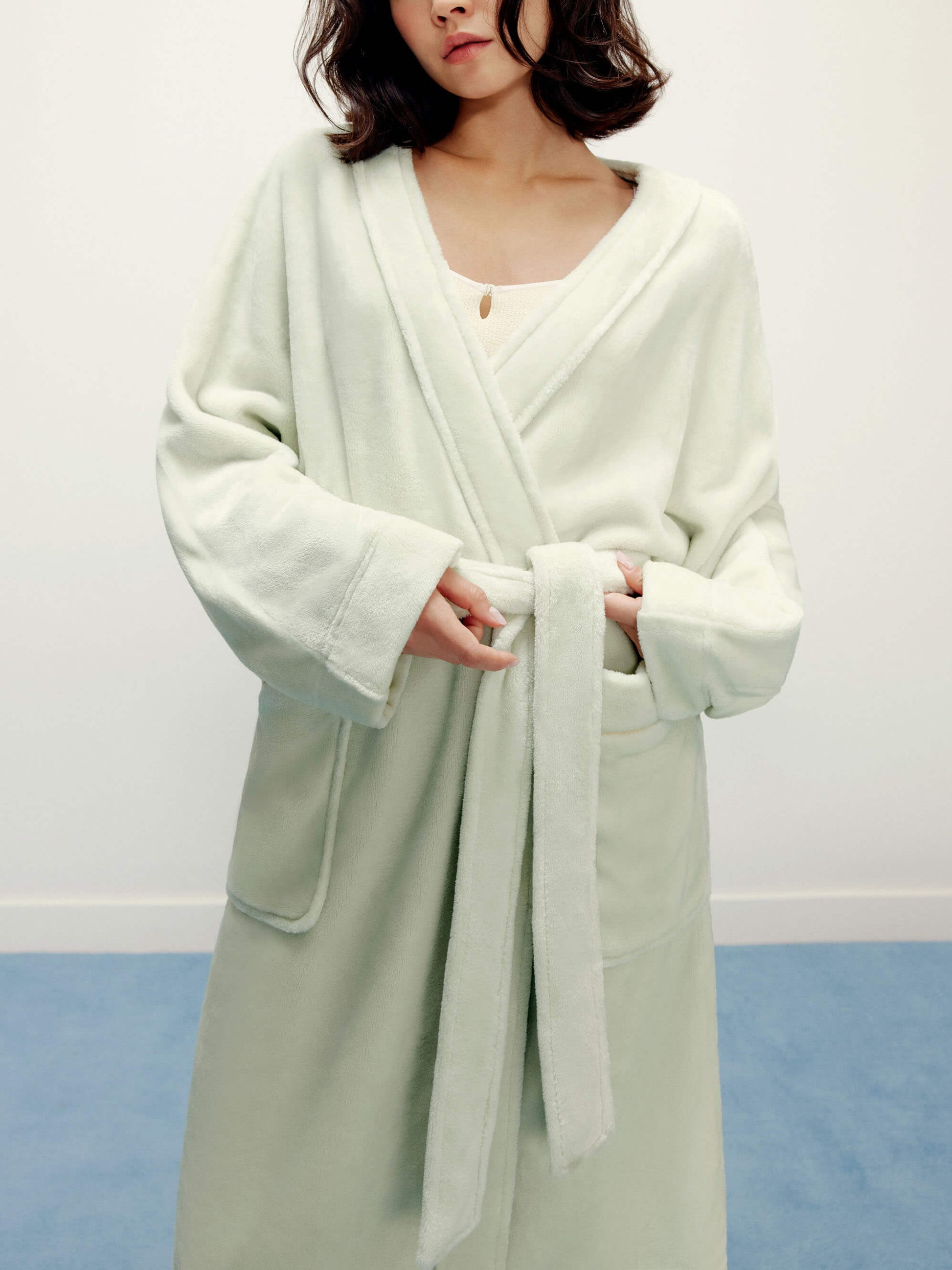  woman wearing a light green fleece robe