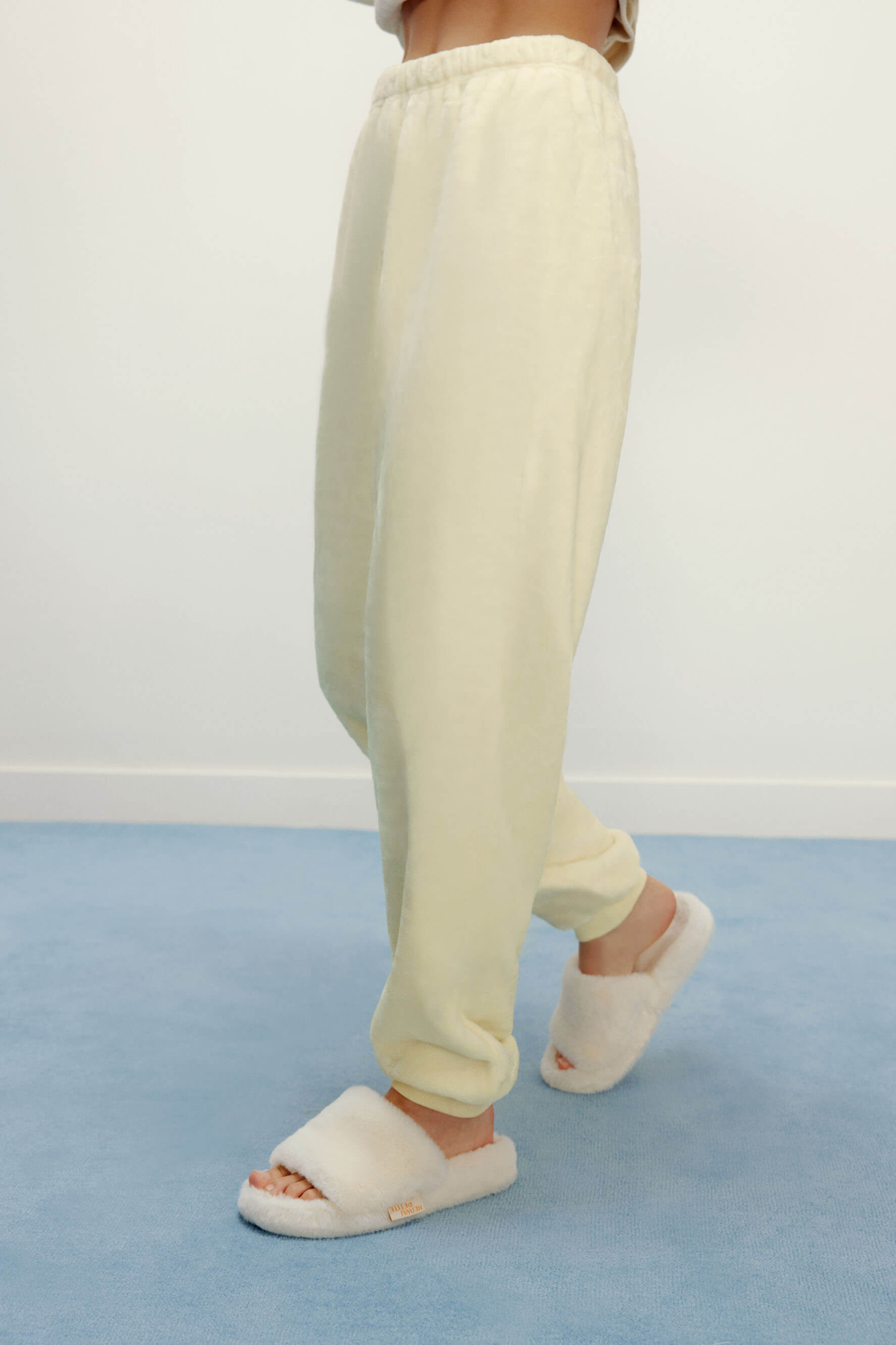 Women Legs with cream color fluffy lounge pants