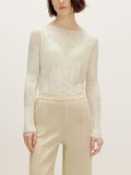 a woman wearing a white sweater and white pants