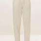 a pair of cream color pants with drawstring waist