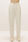 a pair of cream color pants with drawstring waist