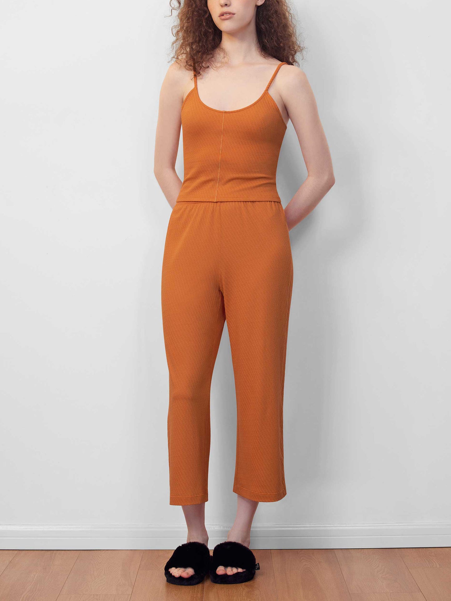 woman in orange cami lounge set