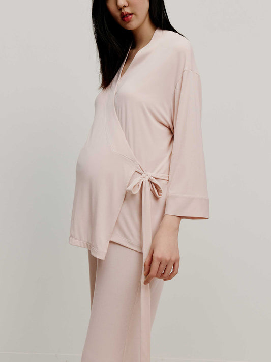 Pregnant woman wearing maternity wrap top