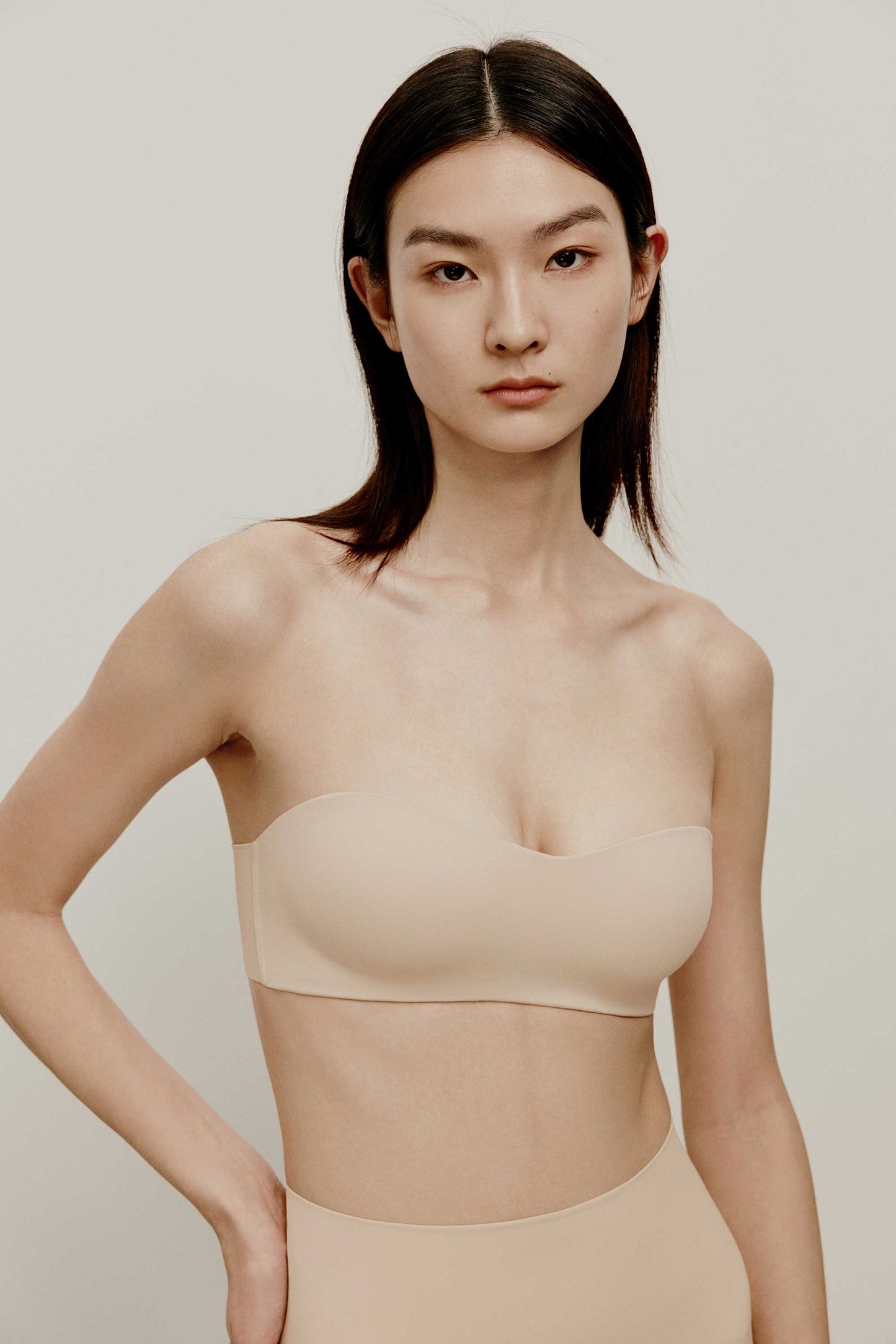 woman in nude strapless bra