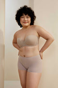 woman in sand wireless bra and light purple shorts