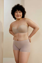 woman in sand wireless bra and light purple shorts
